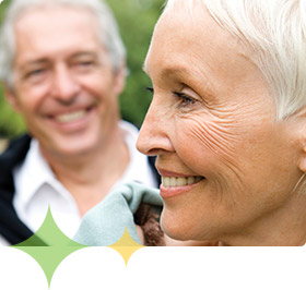 Happy older woman and husband outdoors, representing legal and financial planning for Alzheimer's disease careplanning 